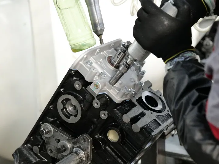 Mechanic working on an engine with tools